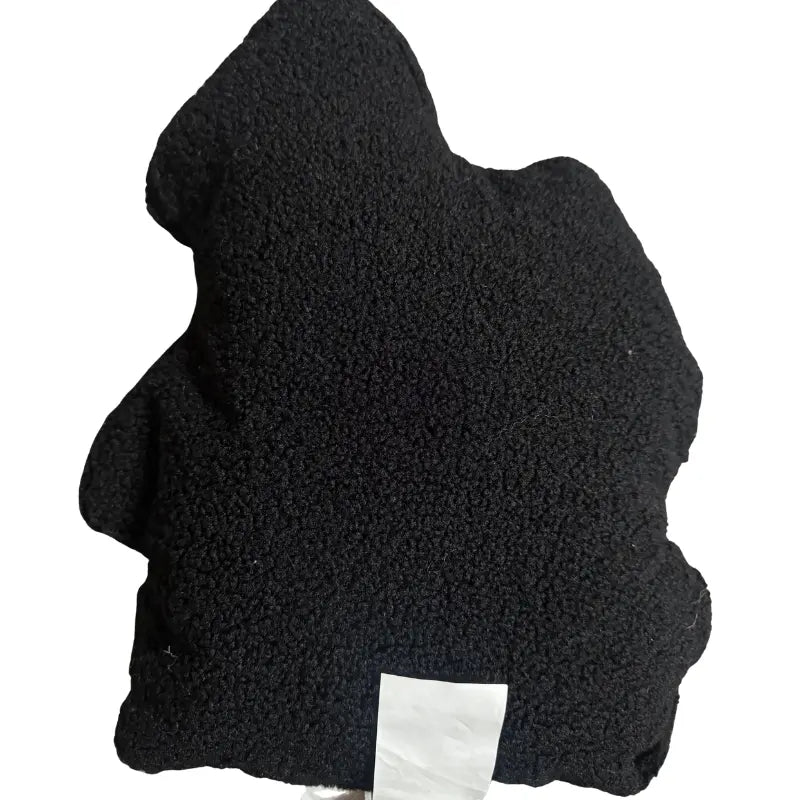 Back view of black sherpa fleece haunted house shaped throw pillow