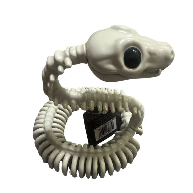 Side angle view of coiled bone skeleton snake prop