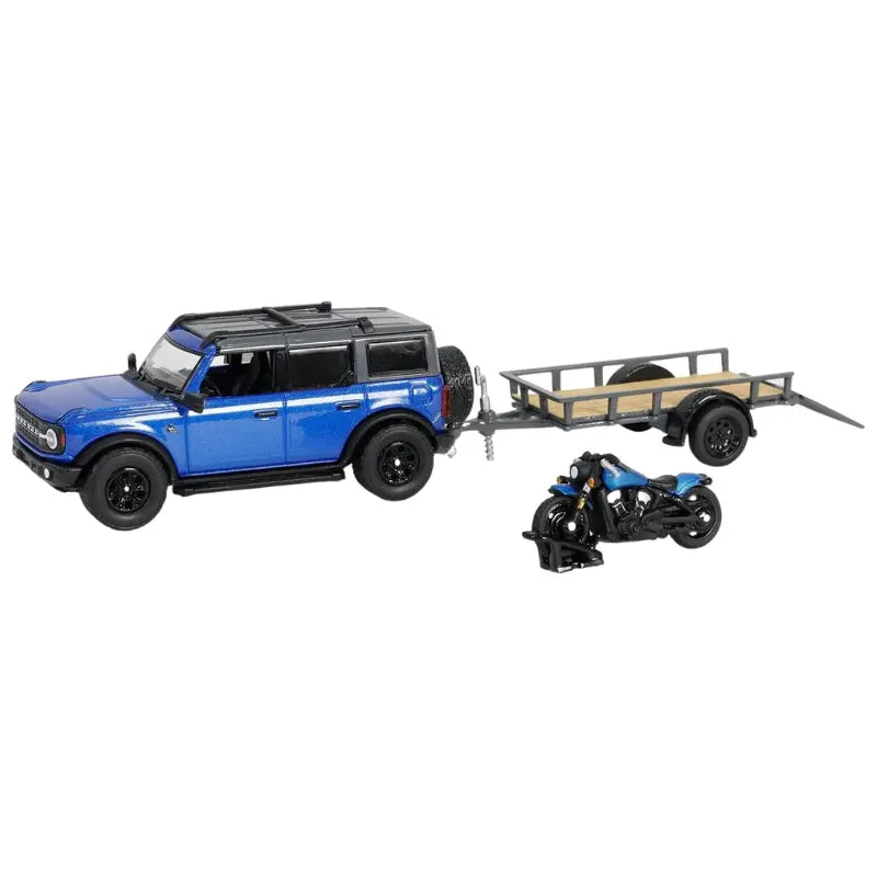 1:64 scale blue 2021 Ford Bronco diecast car with a motorcycle and flatbed trailer.