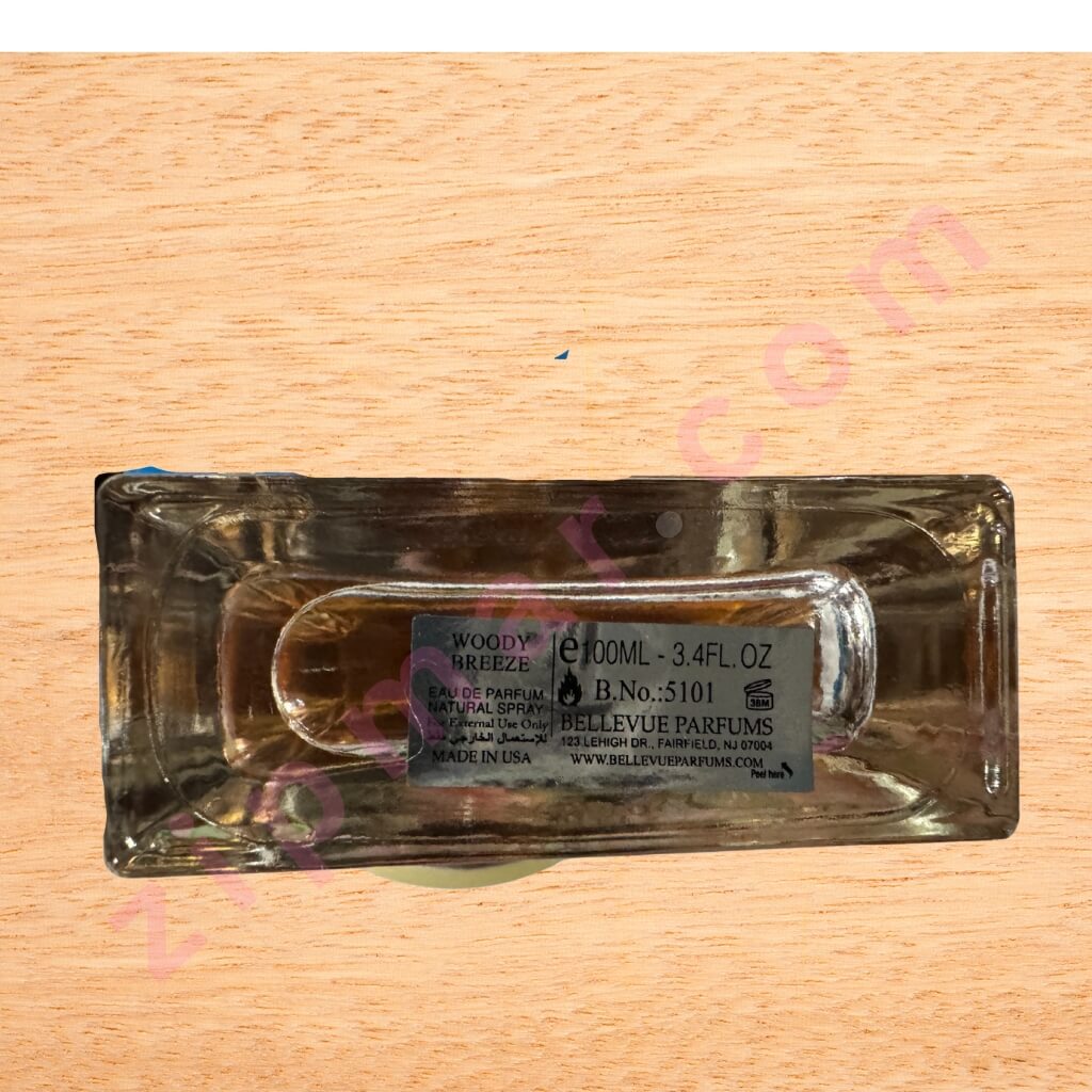 Clear glass perfume bottle with label on a wooden surface