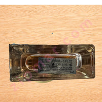 Thumbnail for Clear glass perfume bottle with label on a wooden surface