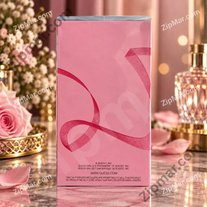 Side of pink Guess Girl eau de toilette box with ribbon design and Guess trademark text