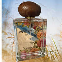 Thumbnail for Perfume bottle with floral design and wooden cap on a natural background