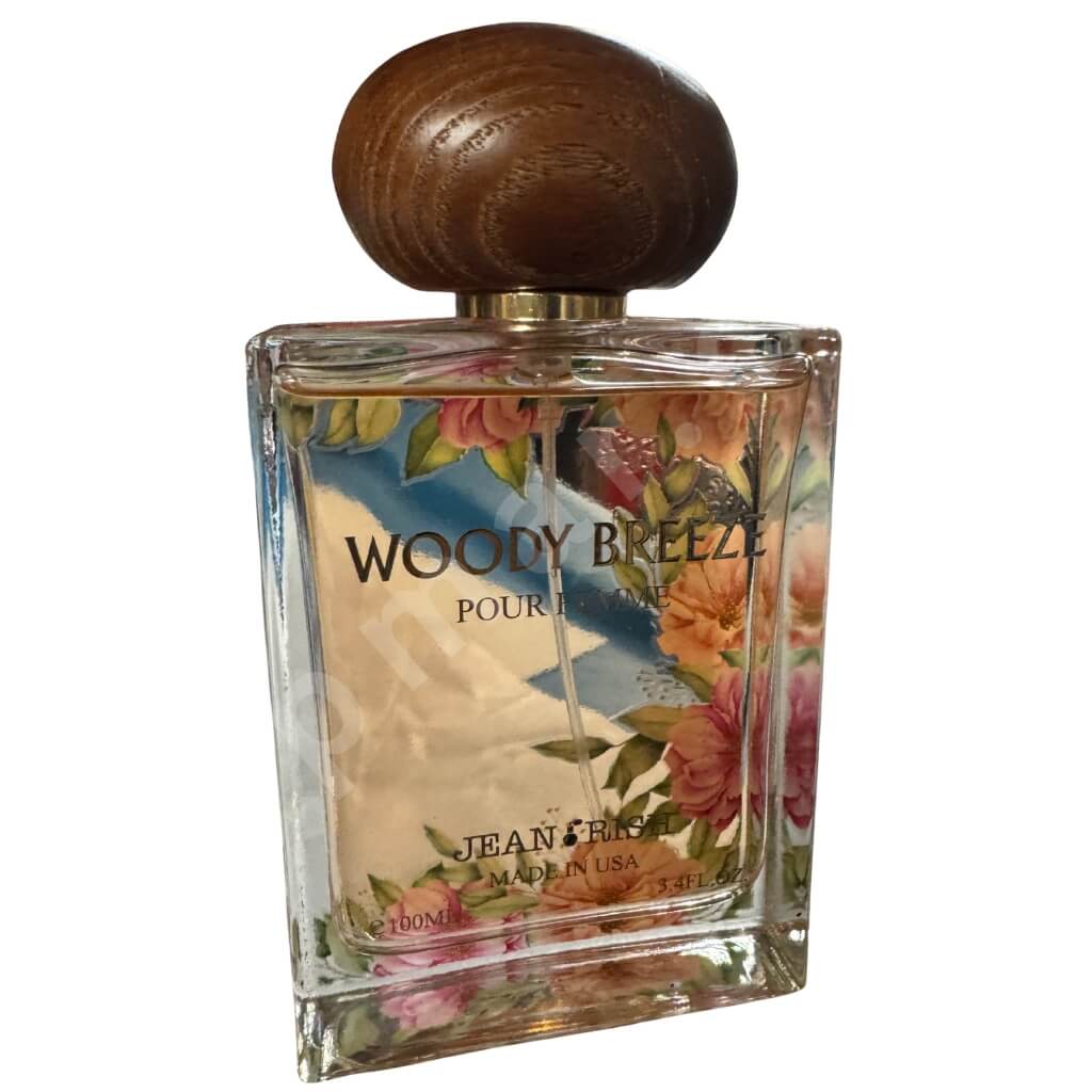 Perfume bottle labeled 'Woody Breeze' with floral design on a white background