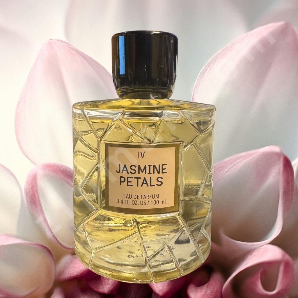 Perfume bottle labeled 'IV Jasmine Petals' surrounded by pink flowers