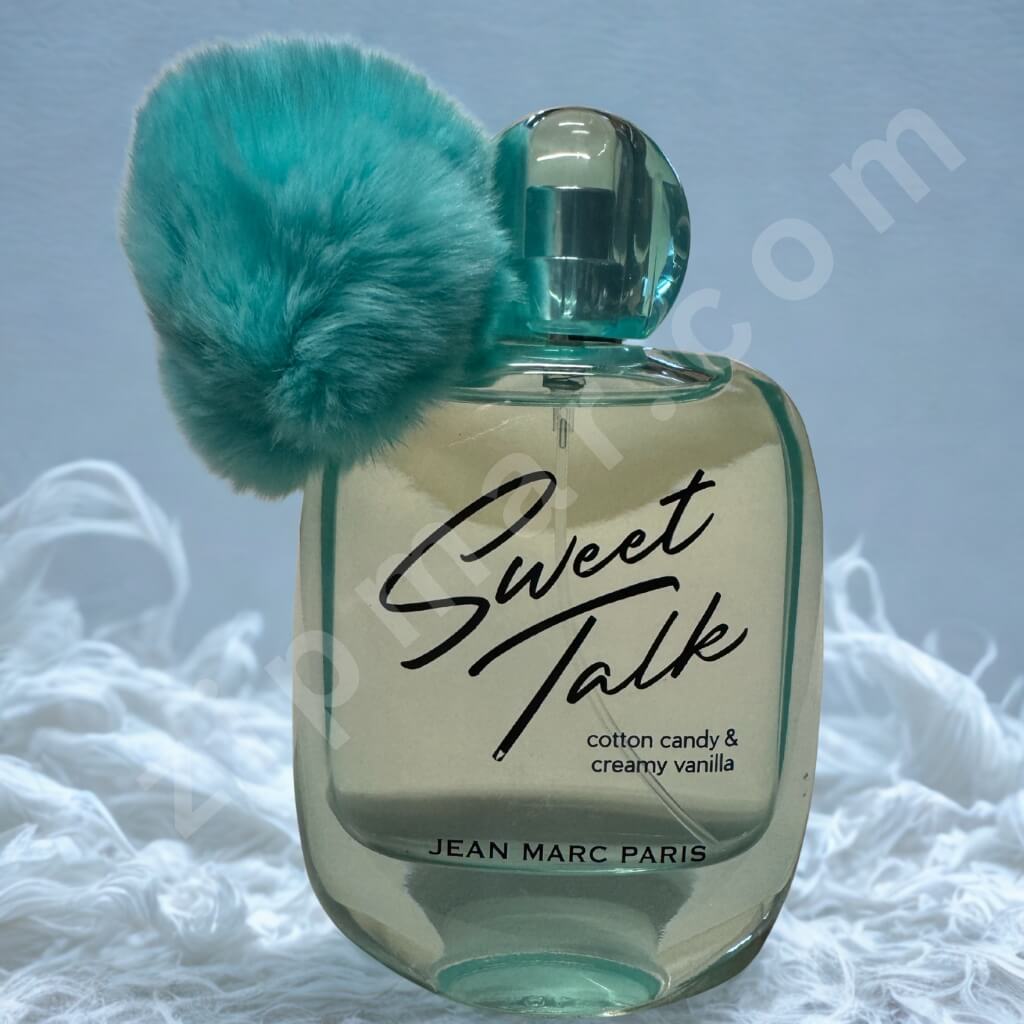 Perfume bottle labeled 'Sweet Talk' by Jean Marc Paris with a turquoise fuzzy ball on a light gray background.