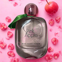 Thumbnail for Perfume bottle labeled 'Pink Apple' by Jean Marc Paris on a pink background with cherries and flowers.