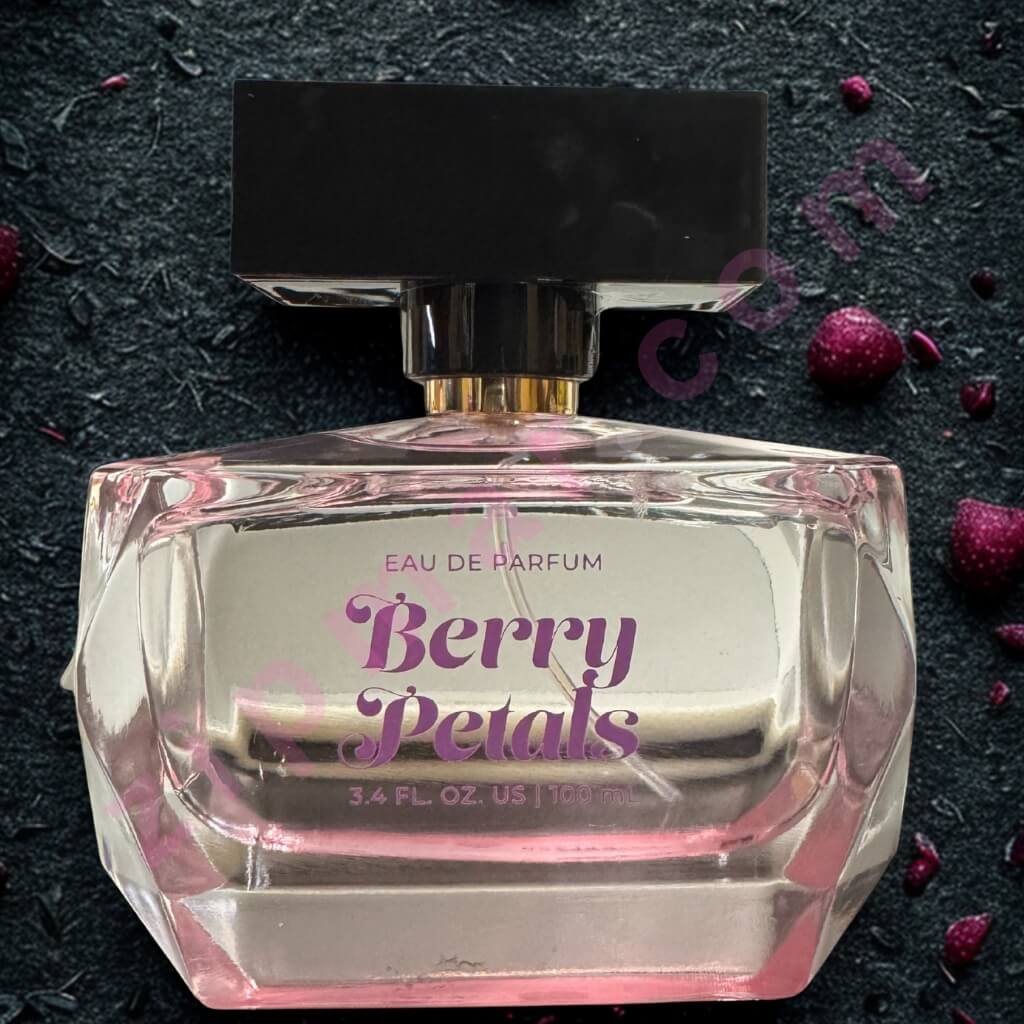 Perfume bottle labeled 'Berry Petals' on a dark textured background