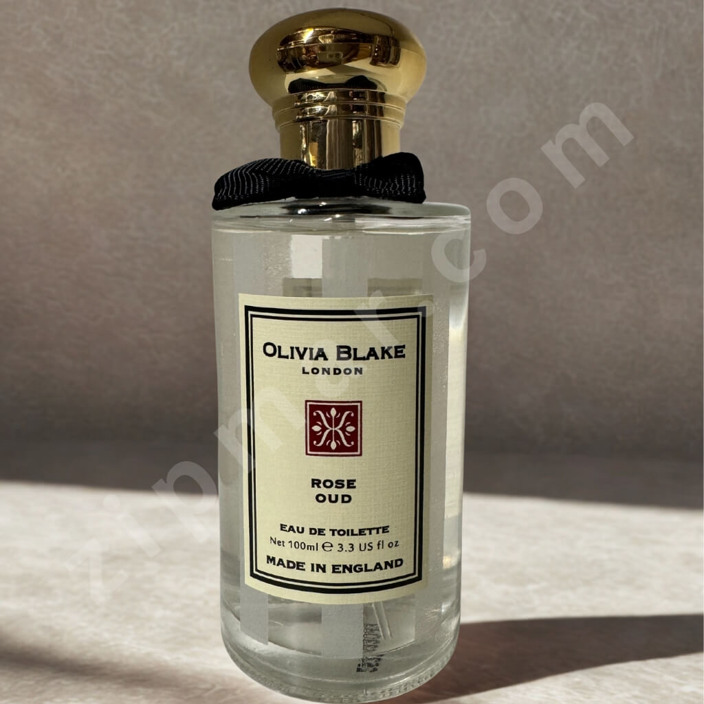 Perfume bottle labeled 'Olivia Blake London' on a neutral background