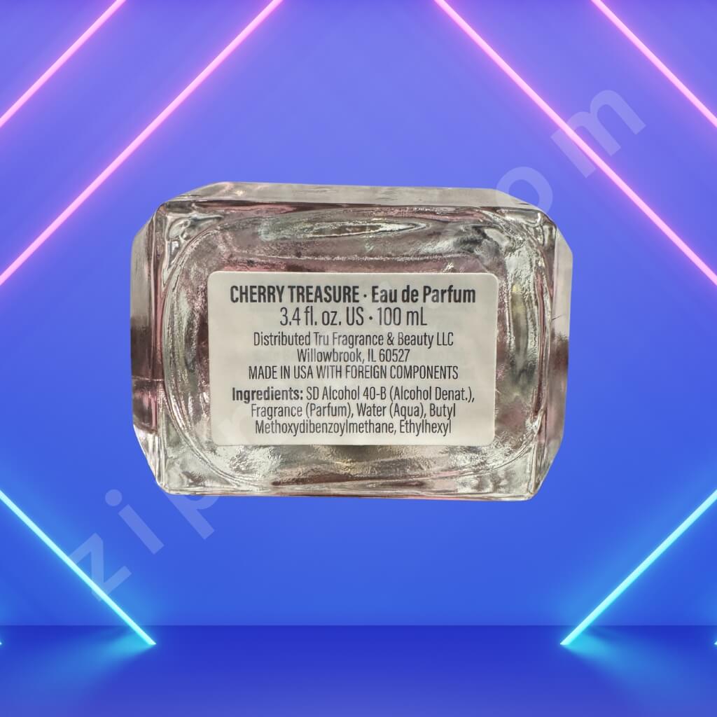 Cherry Treasure eau de parfum bottle with label on a blue and pink neon light background