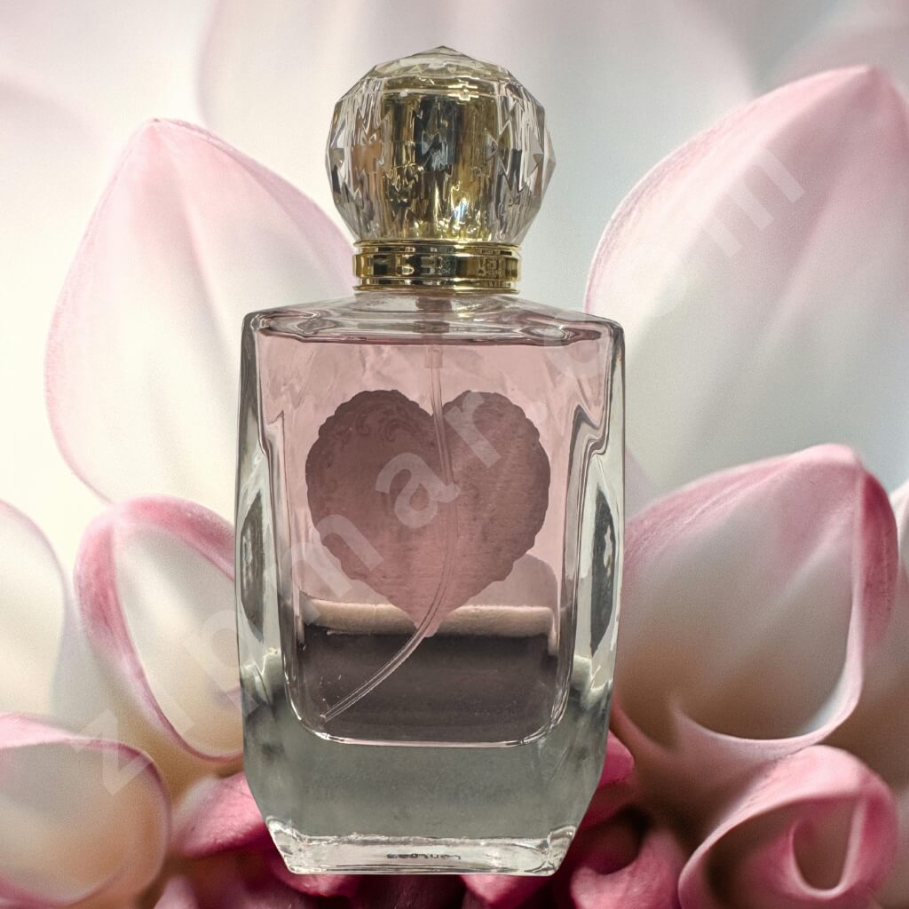 Perfume bottle with decorative cap on pink floral background
