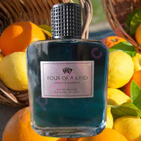 Thumbnail for Perfume bottle labeled 'Four of a Kind' surrounded by lemons and oranges.