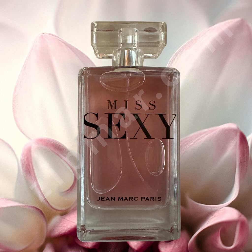 Perfume bottle labeled 'Miss Sexy' by Jean Marc Paris with pink flowers in the background
