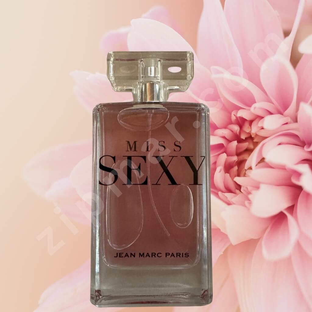 Perfume bottle labeled 'Miss Sexy' by Jean Marc Paris with pink flowers in the background