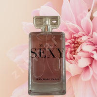 Thumbnail for Perfume bottle labeled 'Miss Sexy' by Jean Marc Paris with pink flowers in the background