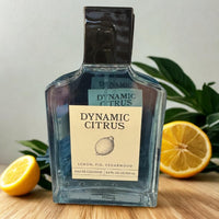 Thumbnail for Bottle of Dynamic Citrus cologne with lemons and greenery in the background