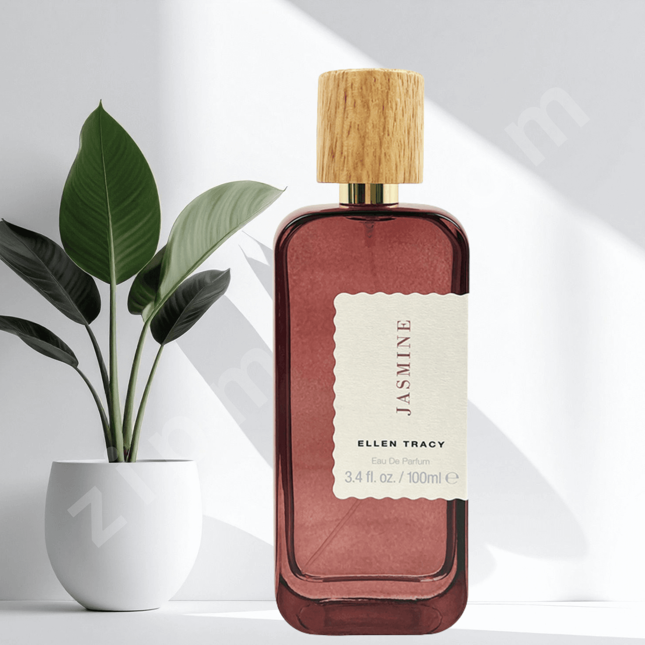 Perfume bottle with wooden cap and 'Jasmine' label on a white background with a plant.