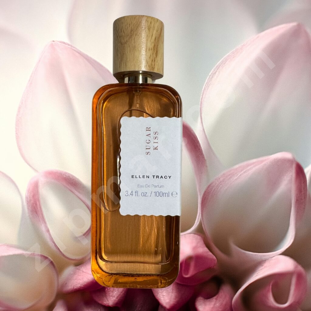 Perfume bottle labeled 'Sugar Kiss' by Ellen Tracy with pink flowers in the background