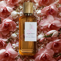 Thumbnail for Perfume bottle labeled 'Sugar Kiss' by Ellen Tracy on a bed of pink flowers