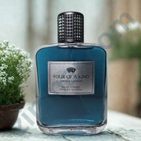 Thumbnail for Blue perfume bottle labeled 'Four of a Kind' on a light surface with plants in the background