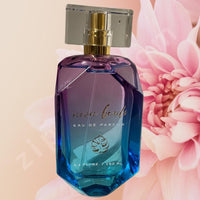 Thumbnail for Blue perfume bottle with gold cap on a pink floral background