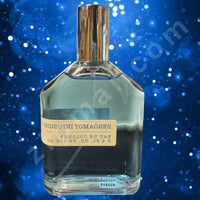 Thumbnail for Perfume bottle with a gold cap on a blue background