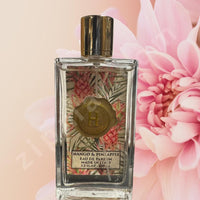 Thumbnail for Perfume bottle with floral design on label against a pink floral background