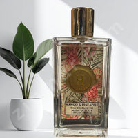 Thumbnail for Perfume bottle with floral design and gold cap on a white background