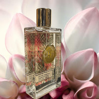 Thumbnail for Perfume bottle with floral design on a pink flower background
