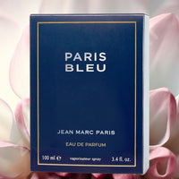 Thumbnail for Blue box of 'Paris Bleu' perfume by Jean Marc Paris with pink flowers in the background