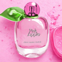 Thumbnail for Pink perfume bottle labeled 'Pink Apple' by Jean Marc Paris on a pink background with water droplets.