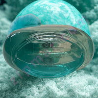 Thumbnail for Teal gelatin capsule on a textured green background