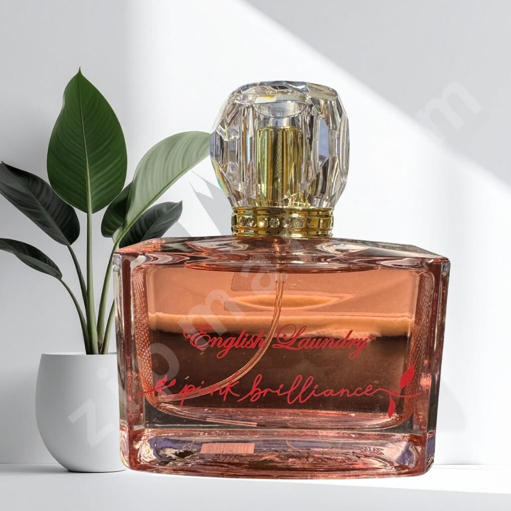 Perfume bottle labeled 'English Laundry' with a plant in the background