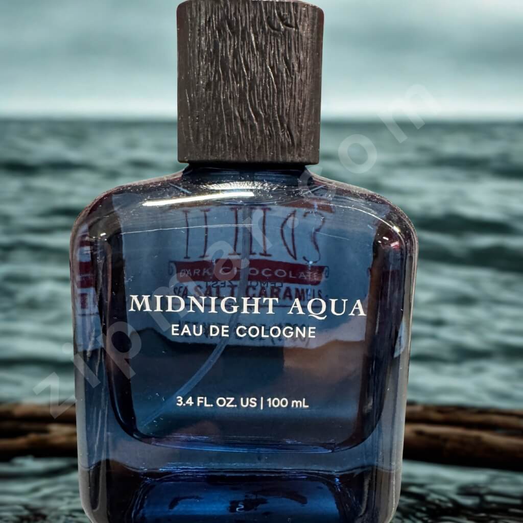 Blue cologne bottle labeled 'Midnight Aqua' with a wooden cap, set against a water background.