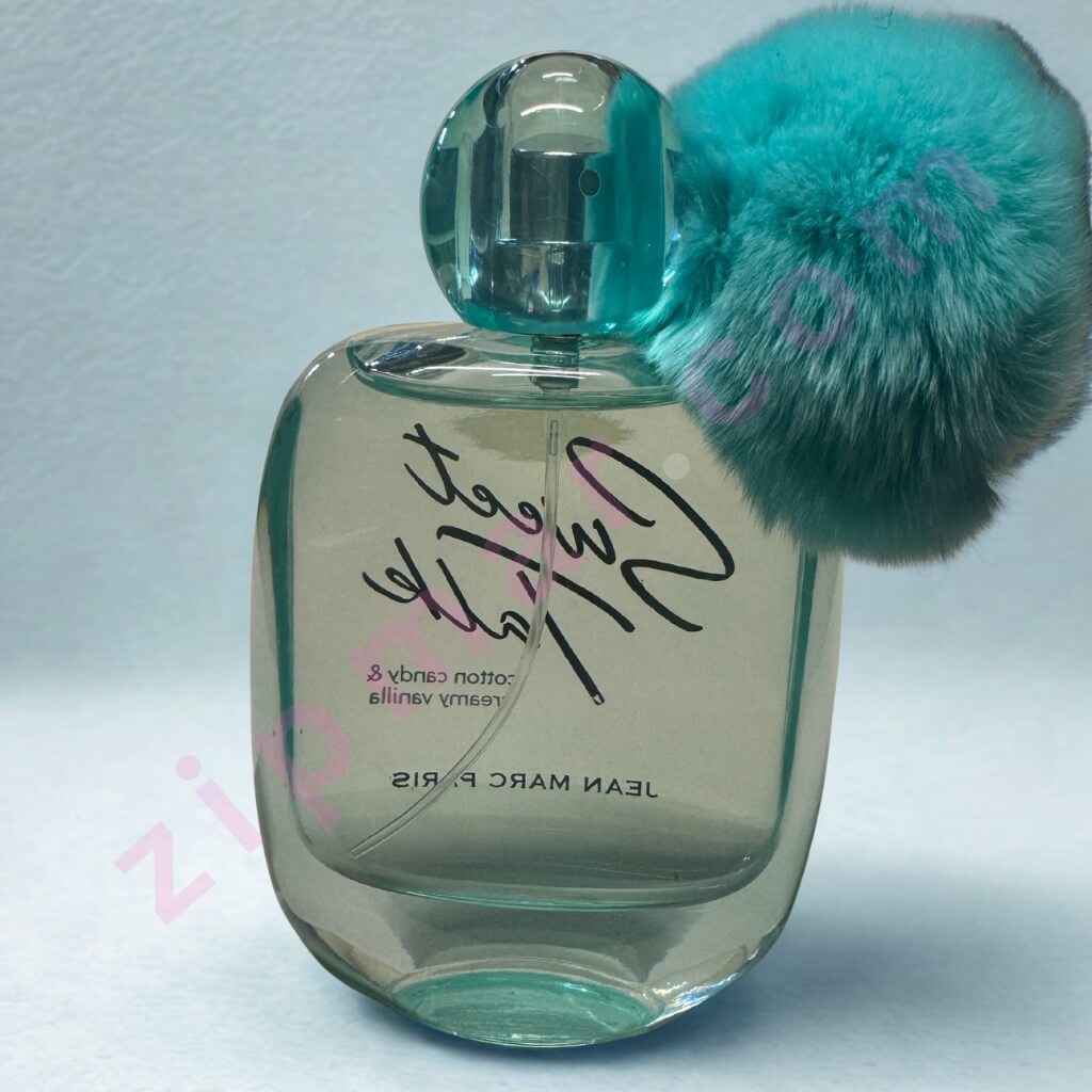 Perfume bottle with a teal cap and visible brand name on a light gray background