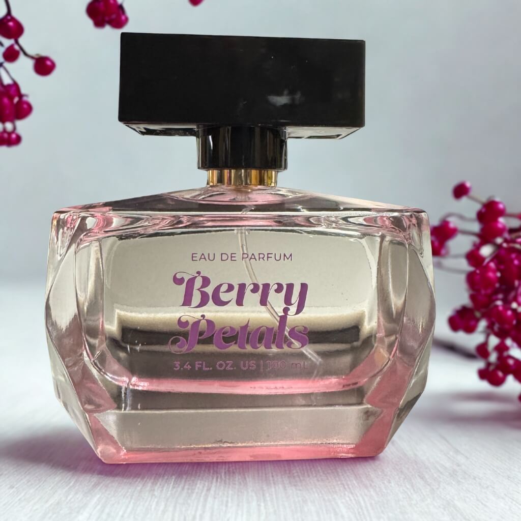 Perfume bottle labeled 'Berry Petals' with a black cap on a light background