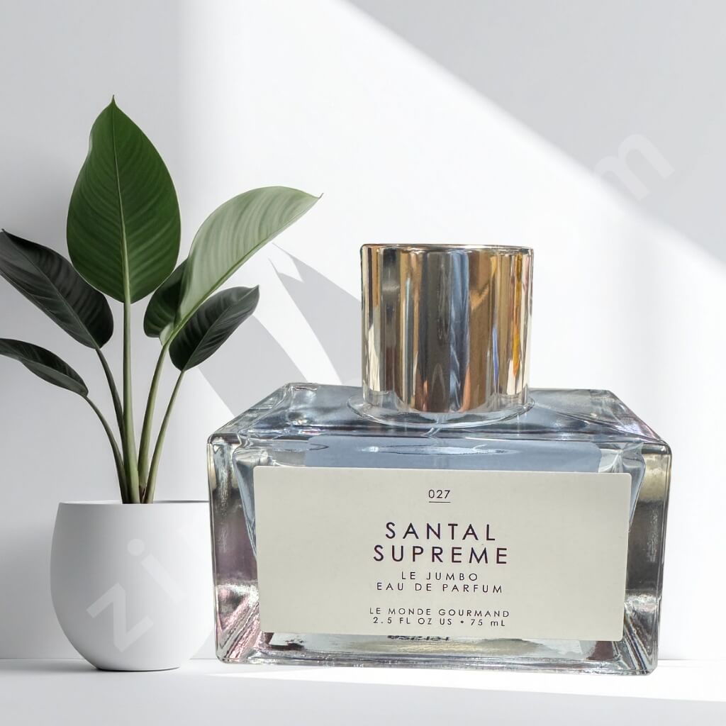 Santal Supreme perfume bottle on a white surface with a plant in the background