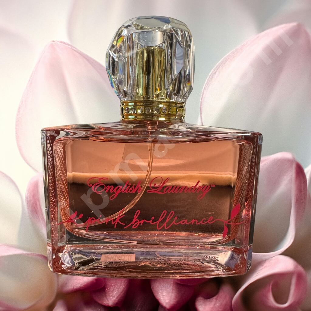Perfume bottle labeled 'English Laundry' on a pink floral background