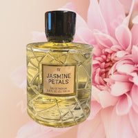 Thumbnail for Perfume bottle labeled 'Jasmine Petals' with a pink flower in the background