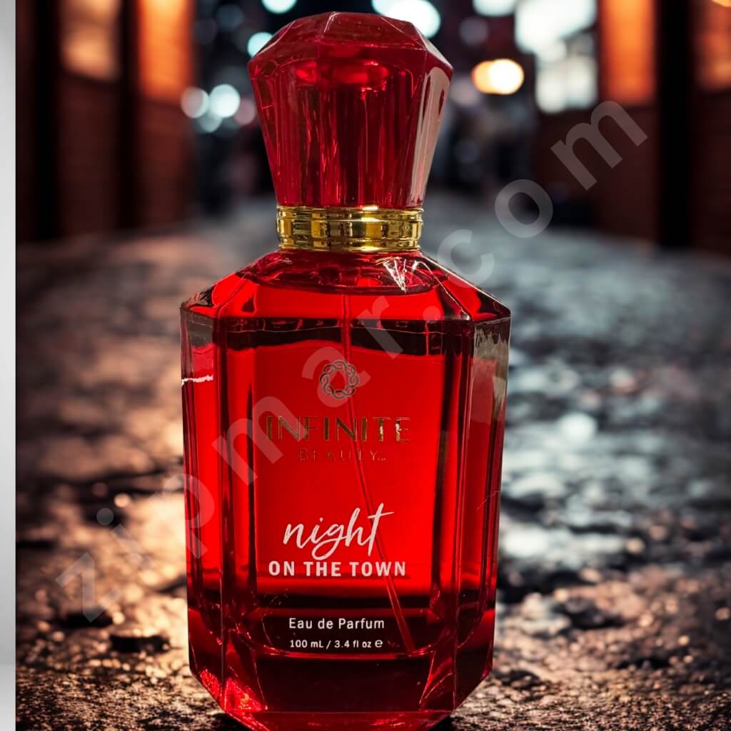 Red perfume bottle labeled 'Night on the Town' on a textured surface with blurred background