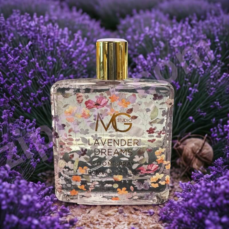 Perfume bottle labeled 'Lavender Dreams' by MG Studio surrounded by lavender flowers.