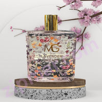 Thumbnail for Perfume bottle labeled 'Lavender Dreams' by MG Studio on a decorative stand with floral elements.