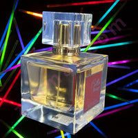 Thumbnail for Clear perfume bottle with a red label on a black background with colorful lights.