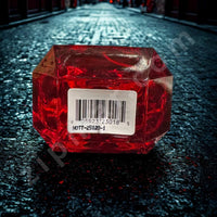 Thumbnail for Red hexagonal container with a barcode label on a dark textured surface