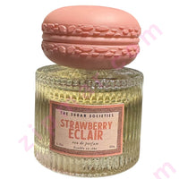 Thumbnail for Perfume bottle with pink macaron-shaped cap labeled 'Strawberry Eclair' by 'The Sugar Societies'.