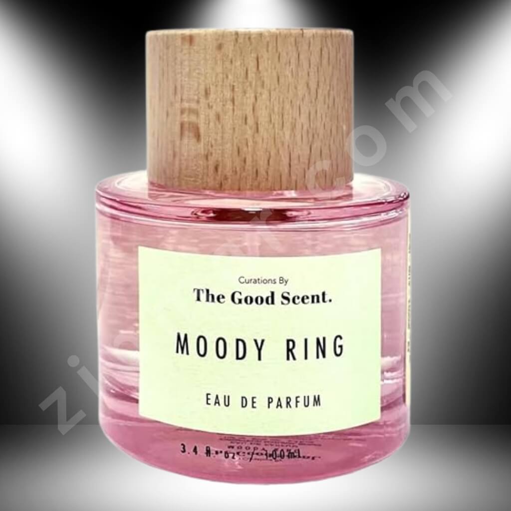 Pink perfume bottle with wooden cap labeled 'Moody Ring' by 'The Good Scent' on a gradient background.