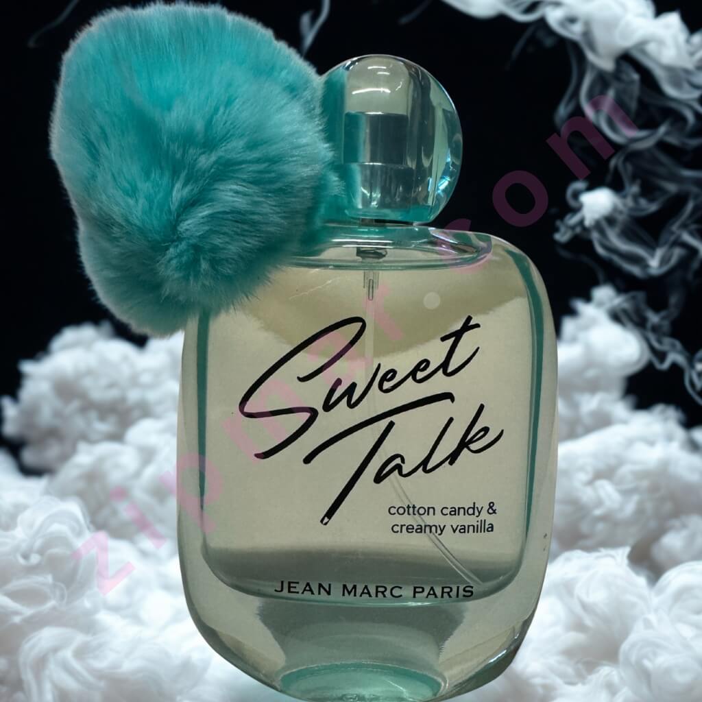 Perfume bottle labeled 'Sweet Talk' by Jean Marc Paris with a teal fuzzy object on a textured white and black background.
