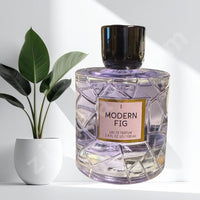 Thumbnail for Perfume bottle labeled 'Modern Fig' with a plant in the background