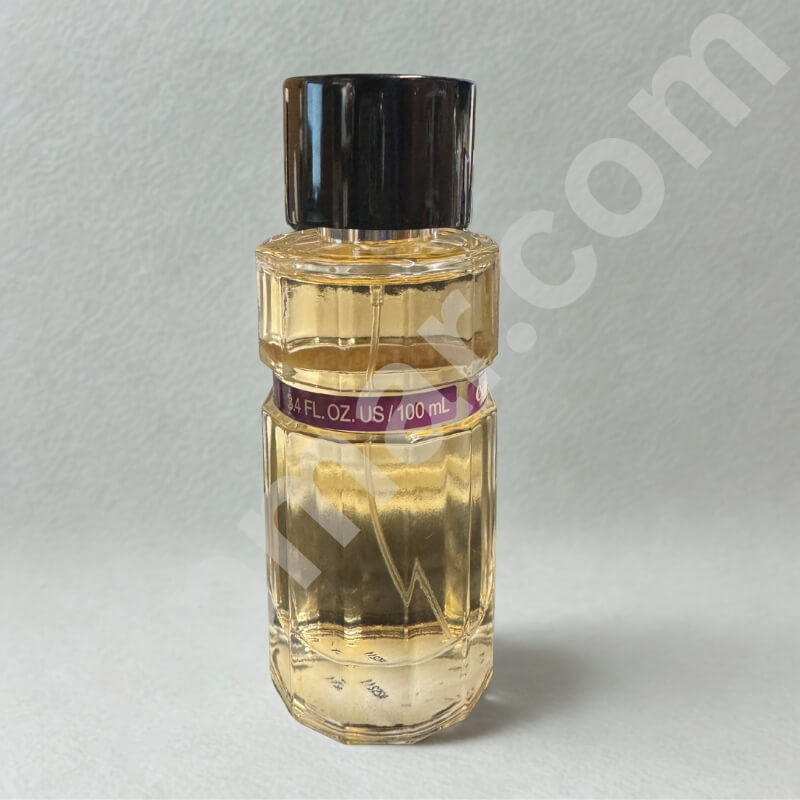 Clear bottle with black cap containing a yellow liquid on a gray background