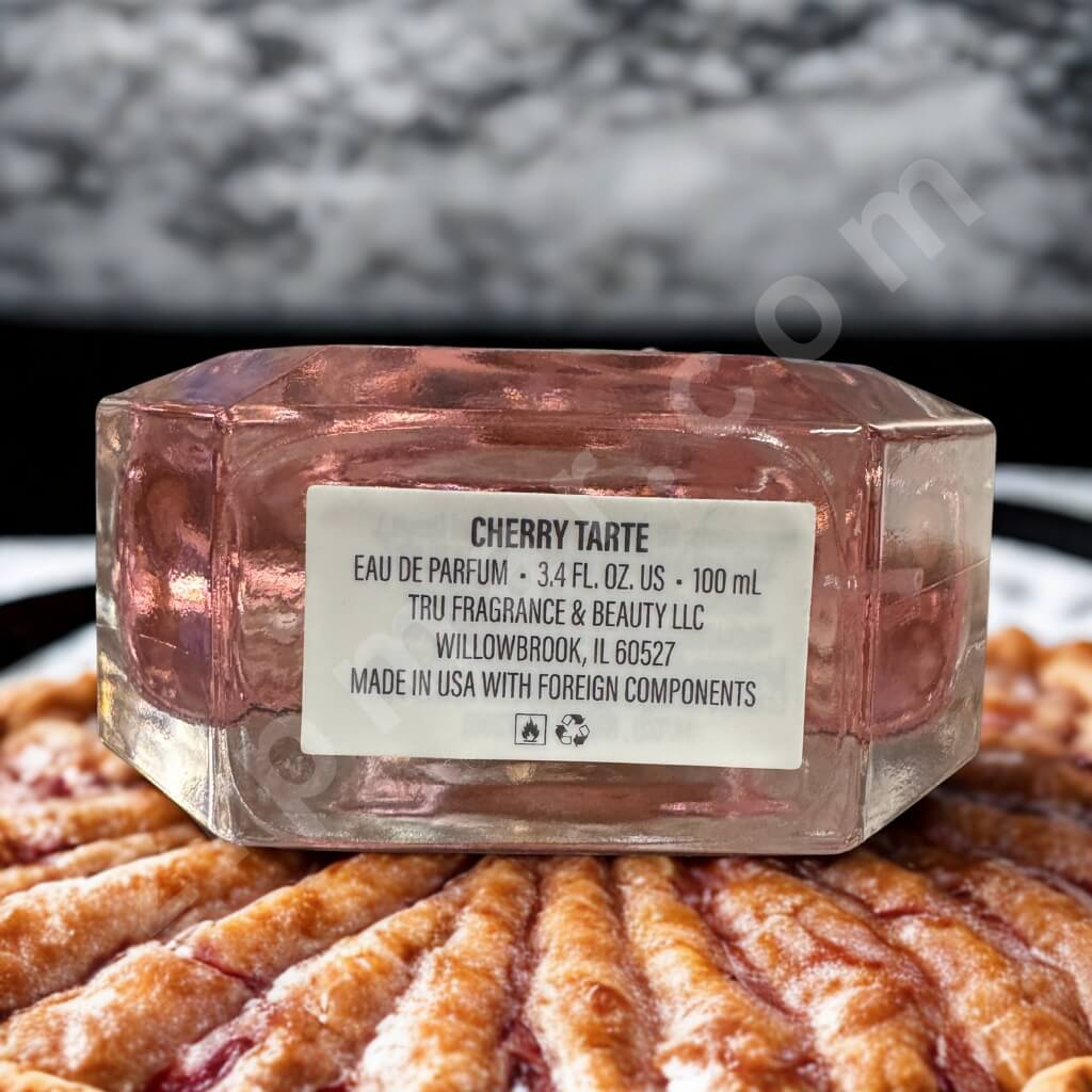 Pink hexagonal container labeled 'Cherry Tarte' with a pie in the background